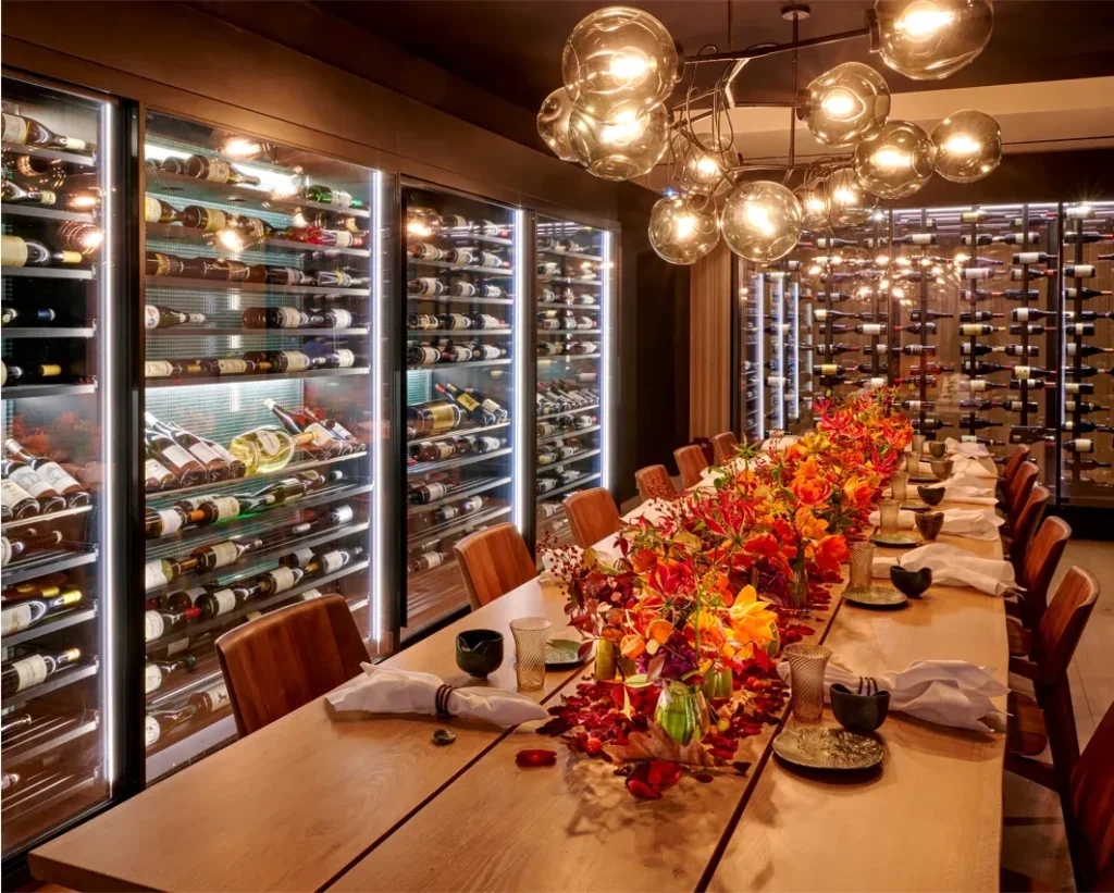 Table with napkins and wine cellar on the wall